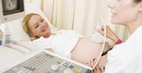 Pregnant woman getting ultrasound from doctor