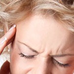 Young woman with a painful headache