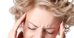 Young woman with a painful headache