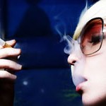 The beautiful girl smokes a cigarette