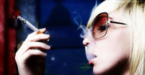 The beautiful girl smokes a cigarette