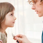 Female doctor examining child