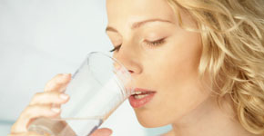 Young beauty blonde woman drinking mineral water