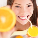 Orange juice drinking woman