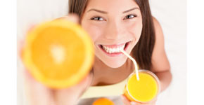Orange juice drinking woman